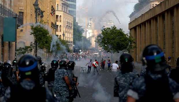 Lebanese riot police fire tear gas at protesters in central Beirut on Saturday.