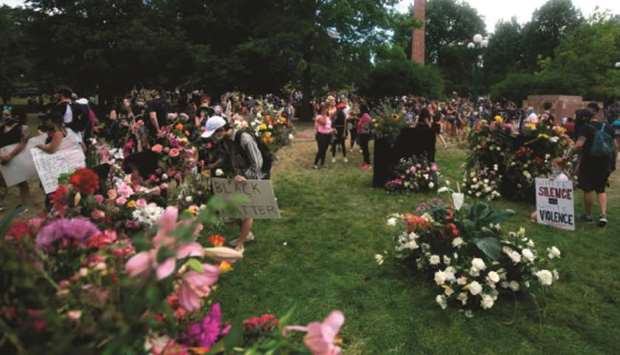 Protesters place flowers at a u2018Flowers for Mr Floydu2019 memorial at War Memorial Park in Denver, Colorado, on Saturday, during a protest over the death of George Floyd.
