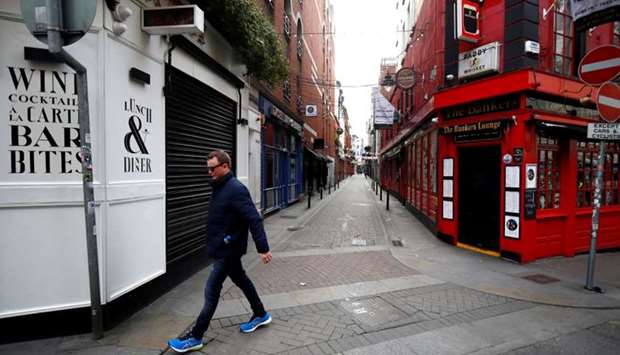 A man walks past a pub in Dublin on St. Patrick's Day as public events were cancelled as the number of coronavirus cases grow around the world, in Dublin, Ireland, March 17