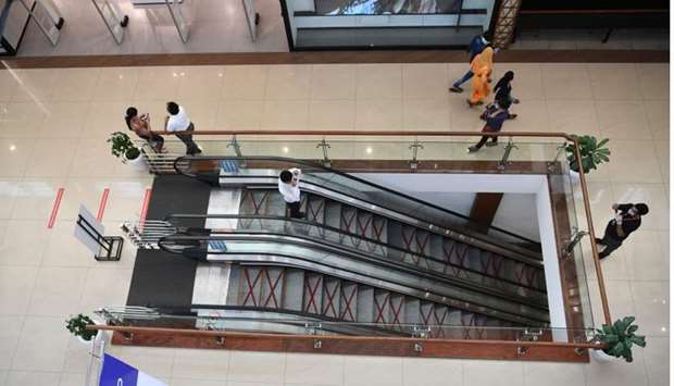 Customers walk inside Select CITYWALK mall after the government eased a lockdown imposed as a preventive measure against the Covid-19 in New Delhi