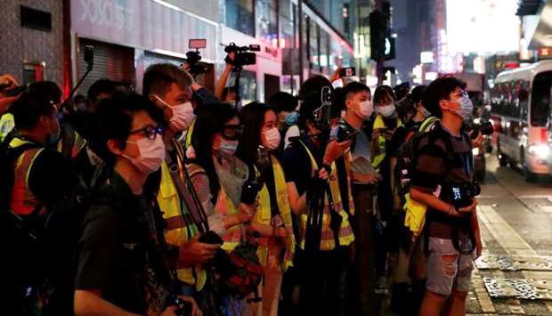 Journalists wearing yellow vests are seen during an anti-government protest to mock Chief Executive Carrie Lam at Mong Kok, in Hong Kong, China, May 13