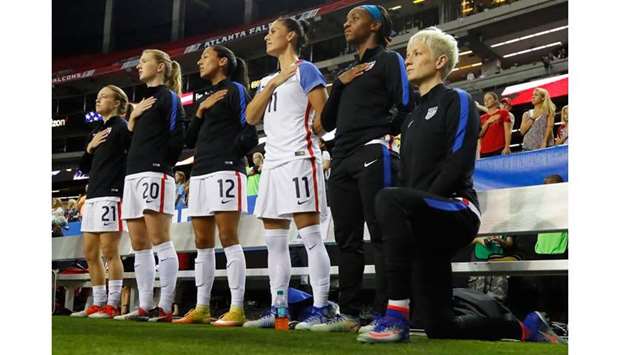 In this file photo taken on September 17, 2016 Megan Rapinoe #15 kneels during the National Anthem prior to the match between the United States and the Netherlands at Georgia Dome in Atlanta, Georgia