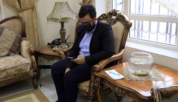 Yemeni physician Sami al-Hajj, who provides free medical service, answers phone calls in the capital Sanaa, during the Covid-19 coronavirus pandemic crisis.