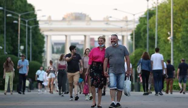 People walk at the Gorky Central Park of Culture and Leisure after local authorities partially lifted quarantine restrictions imposed to prevent the spread of the coronavirus disease, in Moscow. REUTERS