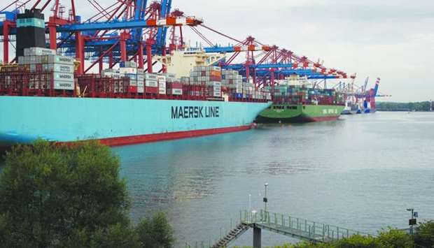 Shipping containers sit on a cargo vessel operated by AP Moeller-Maersk (left) on the dockside at the Eurogate Container Terminal in the Port of Hamburg in Germany. Maersk says the company now sees the global container market contracting this year, compared with a previous forecast for growth of somewhere between 1% and 3%.