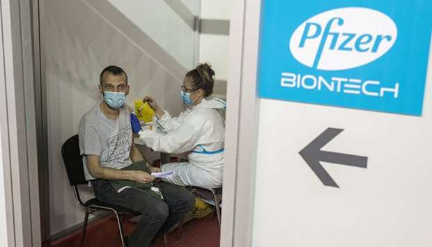 A man receives a second dose of the Pfizer-BioNTech vaccine against the coronavirus disease (Covid-1