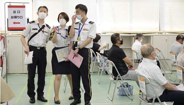 Members of Japan Self Defense Force talk at a mass vaccination site in Tokyo  as Japan Self Defense Force starts a large scale inoculation for Covid-19 vaccine.