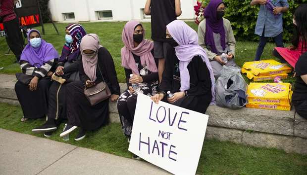 Muslim community members gather for a vigil at the London Muslim Mosque in London, Canada.
