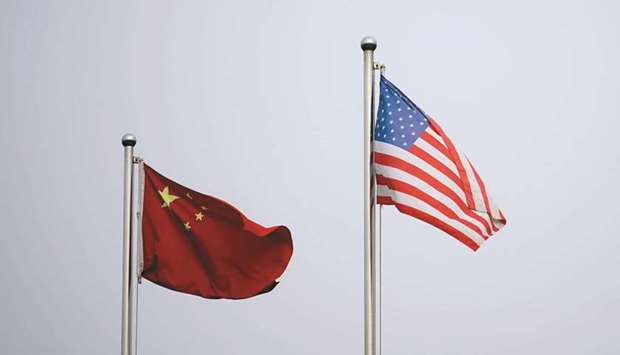Chinese and US flags flutter outside a company building in Shanghai. The two nations are slowly resuming official contact after the January change of administration in the US.