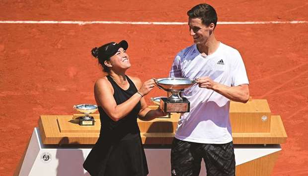 Desirae Krawczyk (left) of the US and Britainu2019s Joe Salisbury celebrate with the trophy after winning the French Open mixed doubles title at Roland Garros in Paris, France, yesterday. (AFP)