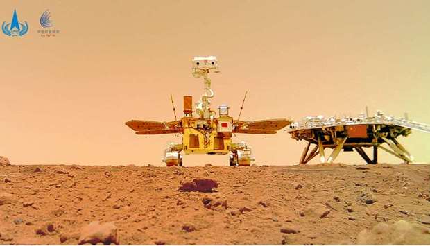 Chinese rover Zhurong and the lander of the Tianwen-1 mission, captured on the surface of Mars by a camera detached from the rover, are seen in this image released by China National Space Administration (CNSA)