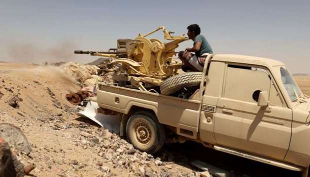 A Yemeni government fighter fires a vehicle-mounted weapon at a frontline position during fighting against Houthi fighters in Marib, Yemen March 28. Reuters