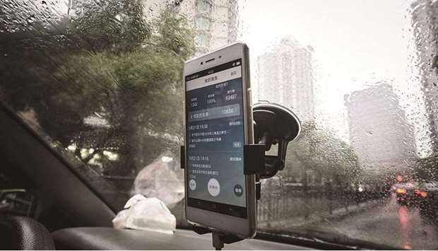 The Didi Chuxing application is displayed on a smartphone screen onboard a vehicle in Shanghai. The Chinese ride-hailing company in its first public filing for the IPO listed the offering as $100mn, a placeholder that will change when the company discloses terms for the share sale.