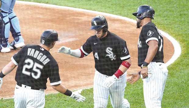 Chicago White Sox catcher Yasmani Grandal (centre) is greeted by teammates Andrew Vaughn (left) and Jose Abreu after hitting a two-run home run against the Toronto Blue Jays at Guaranteed Rate Field in Chicago, Illinois, United States, on Thursday. (USA TODAY Sports)