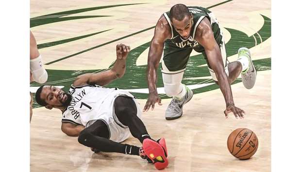 Brooklyn Nets forward Kevin Durant (left) and Milwaukee Bucks forward Khris Middleton reach for a loose ball during game three in the second round of the 2021 NBA Playoffs at Fiserv Forum in Milwaukee, Wisconsin, United States, on Thursday. (USA TODAY Sports)