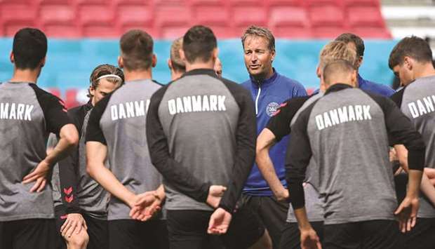 Denmarku2019s coach Kasper Hjulmand talks to his players at a training session at the Parken Stadium in Copenhagen yesterday. (AFP)