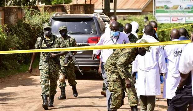 Security forces and forensic experts secure the scene of an attempted assassination on Ugandan minister of works and transport General Katumba Wamala in the suburb of Kiasasi within Kampala, Uganda