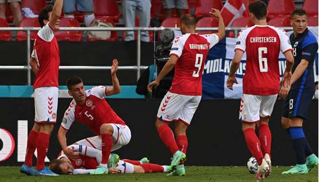 Players call for medics to attend to Denmark's midfielder Christian Eriksen after he collapsed during the UEFA EURO 2020 Group B football match between Denmark and Finland at the Parken Stadium in Copenhagen