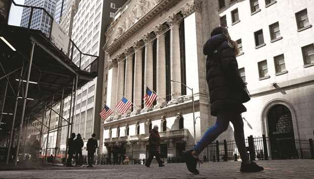 People are seen on Wall Street outside the New York Stock Exchange. Investors will be zeroing in on the Federal Reserveu2019s monetary policy meeting next week as a u201cGoldilocksu201d market environment that has helped lift stocks to record highs and tamed a bond selloff is tested by rising inflation.