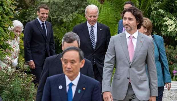 US President Joe Biden (C) and G7 leaders arrive for a family phtotograph during a reception at The Eden Project in south west England on June 11