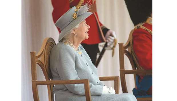 Queen Elizabeth watches the military ceremony at Windsor Castle.
