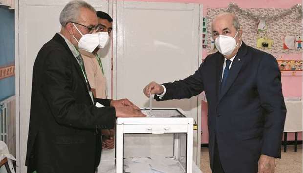 Algeriau2019s President Abdelmadjid Tebboune casts his vote at a polling station during the countryu2019s parliamentary election in Bouchaoui, yesterday.