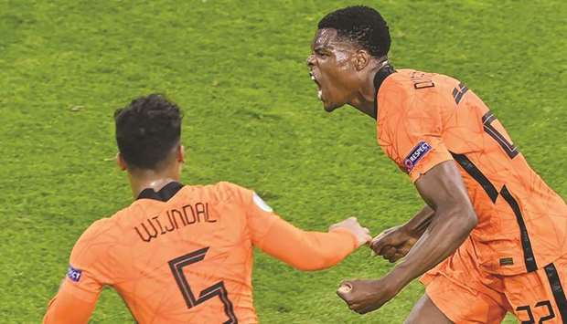 Dumfries (R) celebrates after scoring the third goal for the Netherlands during their UEFA Euro 2020 Group C football match against Ukraine at the Johan Cruyff Arena in Amsterdam yesterday.