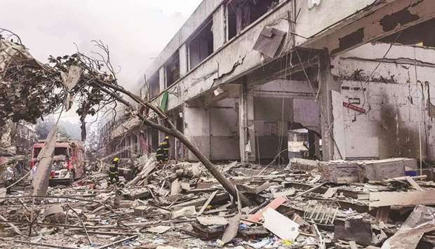 Workers search for victims in a building damaged by a gas line explosion which left at least 12 people dead and nearly 140 others injured in Shiyan, in central Chinau2019s Hubei province yesterday.