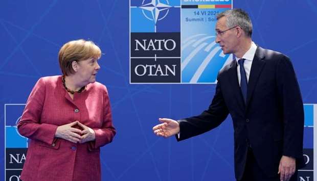 German Chancellor Angela Merkel speaks with Nato Secretary General Jens Stoltenberg as they pose for photos during the Nato summit at Nato headquarters in Brussels, Belgium. Patrick Semansky/Pool via REUTERS