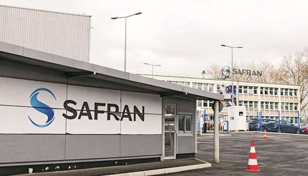 A logo at an entrance to the Safran aircraft engine component plant in Gennevilliers, France. The new project by Safran and GE will pursue hybrid-electric technology and be fully compatible with alternative energy sources such as sustainable aviation fuels and hydrogen.