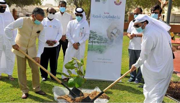 Dr Deepak Mittal and Mohamed Ibrahim al-Saada planting a tree during the event on Monday.