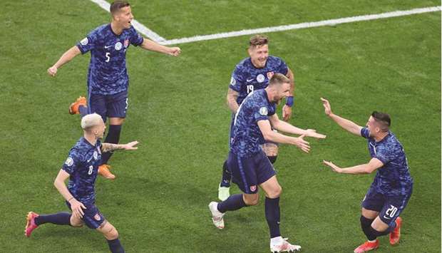 Slovakiau2019s Milan Skriniar (Right) celebrates with his teammates after scoring their second goal against Poland yesterday.