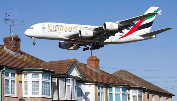 An Emirates Airbus A380 aircraft is seen above roof top