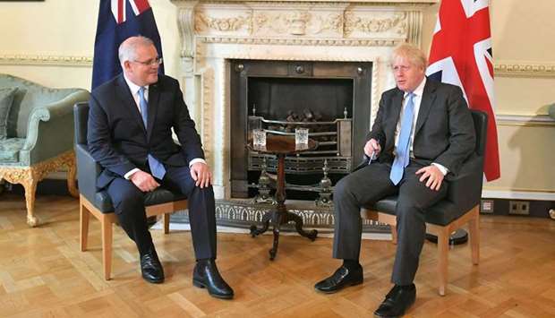 Britain's Prime Minister Boris Johnson (R) talks with Australia's Prime Minister Scott Morrison during their meeting at 10 Downing street in central London