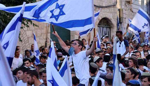 Israelis lift flags as they take part in the ultranationalist March of the Flags. AFP