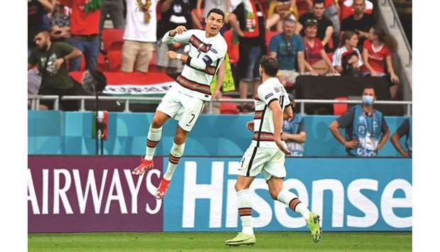 Portugalu2019s Cristiano Ronaldo celebrates scoring their third goal against Hungary yesterday.