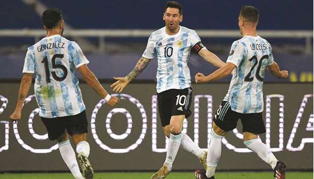 Argentinau2019s captain Lionel Messi (centre) celebrates with teammates Nicolas Gonzalez (left) and Giovani Lo Celso after scoring a free-kick against Chile during the Copa America match at the Nilton Santos Stadium in Rio de Janeiro, on Monday. (AFP)