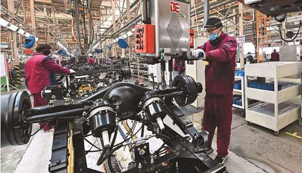 Employees work on a truck assembly line at a factory for the vehicle manufacturing company Jianghuai Automobile Group in Qingzhou in eastern Chinau2019s Shandong province. Growth in Chinau2019s factory output slowed for a third straight month in May, likely weighed down by disruptions caused by Covid-19 outbreaks in the countryu2019s southern export powerhouse of Guangdong.