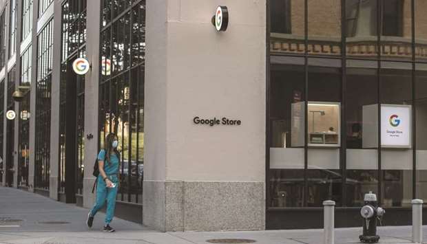 A pedestrian passes in front of the Google Store Chelsea in New York. The store will open to the public today, the Mountain View, California-based company said in a blog post yesterday.