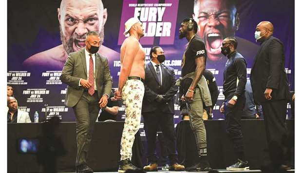 Boxers Tyson Fury and Deontay Wilder (third from right) face-off on Tuesday in Los Angeles during a press conference to announce their third WBC heavyweight championship fight scheduled for July 24. (AFP)