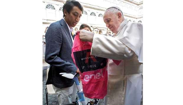 Pope Francis receives the Giro du2019Italia pink jersey from Colombian rider Egan Bernal at the Vatican yesterday. (Reuters)