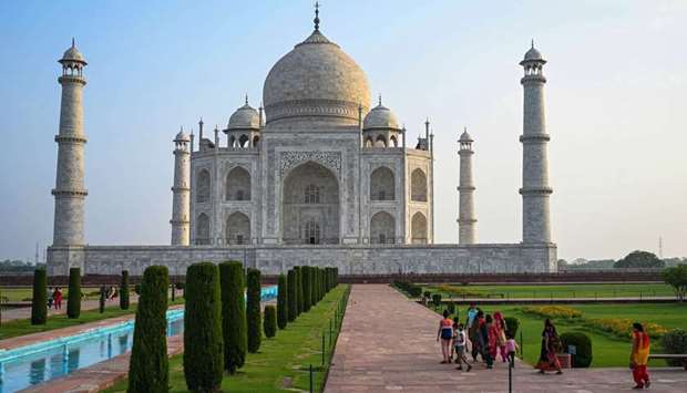 Tourists visit the Taj Mahal after it reopened to visitors following authorities easing Covid-19 coronavirus restrictions in Agra