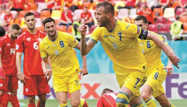 Ukraineu2019s Andriy Yarmolenko (right) celebrates after scoring against North Macedonia in Bucharest yesterday. (Reuters)