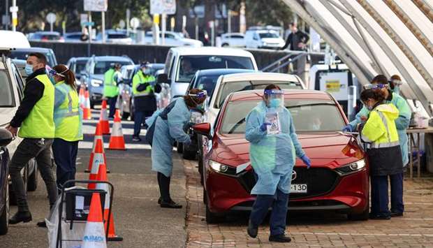 Medical workers administer tests at the Bondi Beach drive-through coronavirus disease (COVID-19) testing centre in the wake of new positive cases in Sydney, Australia