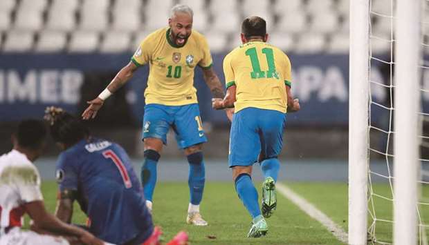 Brazilu2019s Everton Ribeiro (right) celebrates with Neymar after scoring against Peru in the Copa America Group B match at the Estadio Nilton Santos in Rio de Janeiro on Thursday night. (Reuters)