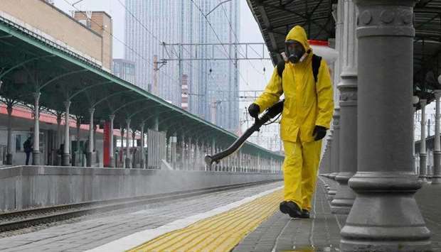 A specialist wearing personal protective equipment (PPE) sprays disinfectant while sanitizing the Rizhsky Railway Station, in Moscow, Russia June 17, 2021. (AFP)
