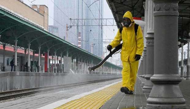 A specialist wearing personal protective equipment (PPE) sprays disinfectant while sanitizing the Rizhsky Railway Station, in Moscow, Russia June 17, 2021. (AFP)