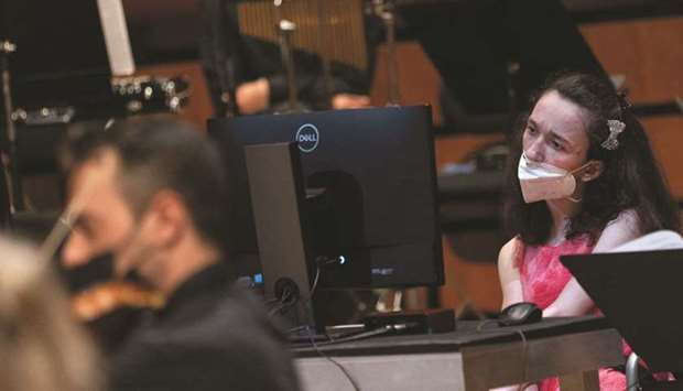 Alexandra Kerlidou, who suffers from cerebral palsy, plays the u2018Eyeharpu2019, a gaze-controlled software that allows those with disabilities to play music, during a concert in Athens.