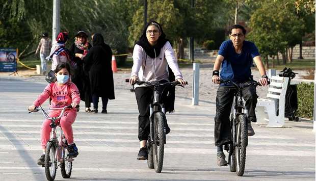 Iranians ride their bicycles around the artificial Chitgar lake in Tehran (file). Prior to Trumpu2019s sanctions, the International Monetary Fund had expected Iranu2019s GDP to grow by about 4% in 2019, but instead it shrank by more than 6%.