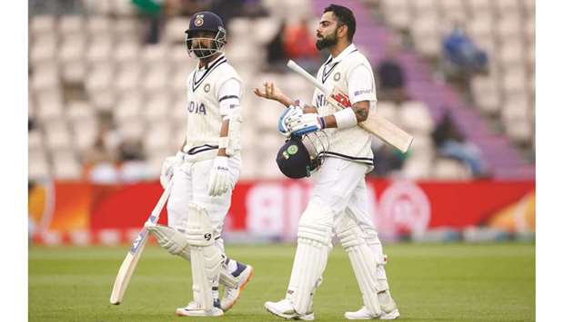 Indiau2019s Virat Kohli and Ajinkya Madhukar Rahane walk off the pitch after play was stopped due to bad light in Southampton yesterday.